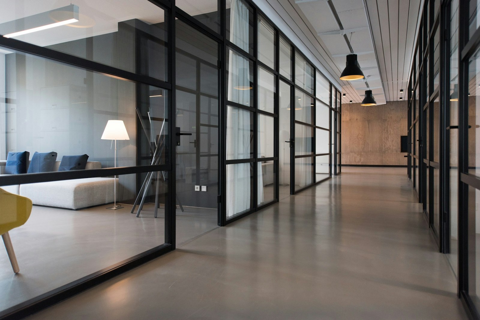 Minimalist modern office with glass partitions.